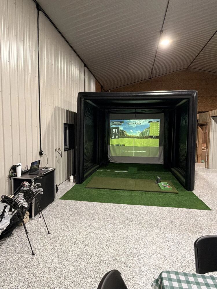 Indoor mobile golf simulator enclosure set up and ready to play